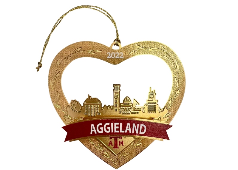 Product Description: This year's Christmas in Aggieland ornament celebrates the very core of Aggieland's treasured traditions - the campus itself. The campus skyline conjures shared memories in the hearts of all Aggies - the sun setting over the green lush lawn at Blue Bell Park; the camaraderie, cooking and Texas-sized fun tailgating at every single football game; a rushed glance at the Clock Tower between classes; the silence and awe of Muster; the majesty and permanence of The Century Tree, lifetime friendships made and destinies united by the history and traditions of Texas A&M University. There are many famous skylines in the world, but we know none burns brighter in the hearts of Aggies than that of Aggieland.</br></br>Enjoy this year's "I love Aggieland" Christmas ornament and, as it sparkles gold and bright in your Christmas tree, know that you have made a difference. Our Christmas in Aggieland ornaments benefit children and adults with temporary or short-term disabilities receiving therapy right here at home - in Aggieland.</br></br>Merry Christmas and Gig 'em!</br> 2022 -  I Love Aggieland