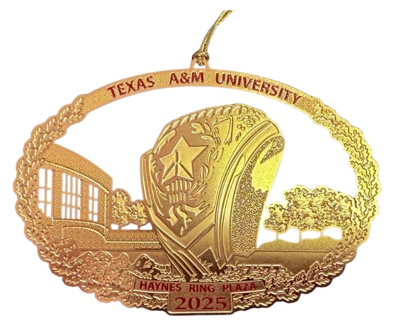 Product Description: Crafted by the talented local artist, Dr. Dary Dega of DEGALLERY (degallery.us), this year's Christmas in Aggieland ornament showcases the beautiful Haynes Ring Plaza, a cherished spot for former, current and aspiring Aggie students, as well as visitors to Texas A&M University’s campus. At the heart of the Haynes Ring Plaza stands a colossal Aggie Ring, cast in bronze and weighing over 3 tons. Unveiled at the Clayton W. Williams, Jr. Alumni Center during Aggie Ring Day festivities in 2009, this iconic symbol holds a special place in the hearts of the Aggie community. The plaza itself, when seen from above, forms the distinct shape of an Aggie Ring, adding an extra touch of brilliance to its design. As you hang the 2025 Christmas in Aggieland ornament, let it be a reminder of the rich Aggie traditions, and how Aggies support and enrich our community every day! Wishing you a Merry Christmas and a spirited Gig 'em!</br> 2025- Haynes Ring Plaza
